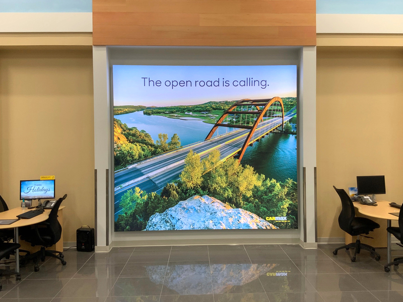 The open road is calling - showroom lightbox at CarMax.